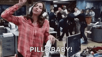 a woman wearing headphones is dancing in an office while holding a piece of paper and says `` pills baby '' .