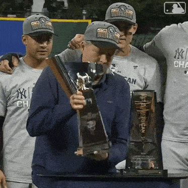 a man holding a trophy that says ' american league world series ' on it