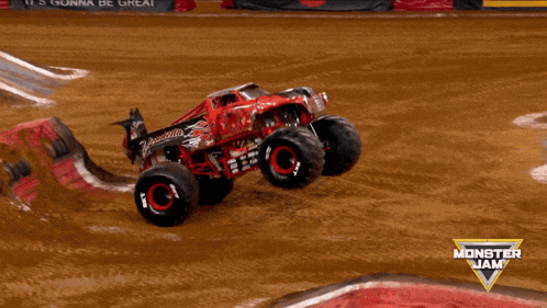 a monster jam advertisement with a red monster truck on its side
