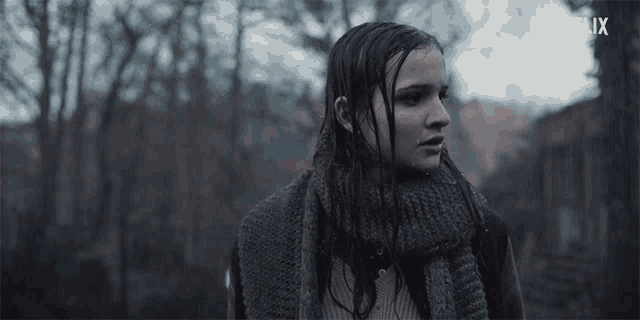 a woman with a scarf around her neck and a netflix logo on the bottom
