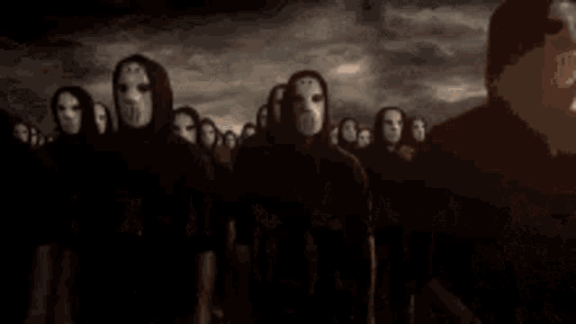 a group of people are standing in a line with their faces visible
