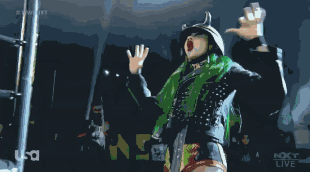 a woman with green hair is standing in front of a microphone with usa written on the bottom