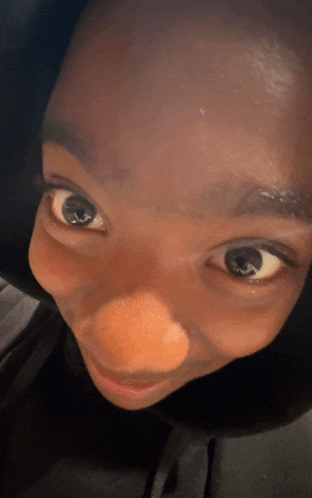a close up of a person 's face with a black shirt on