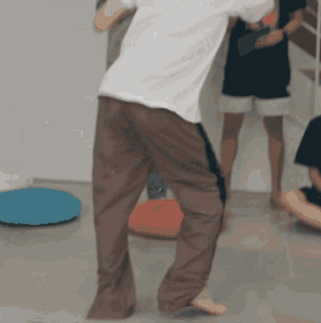 a person wearing brown pants and a white shirt is dancing
