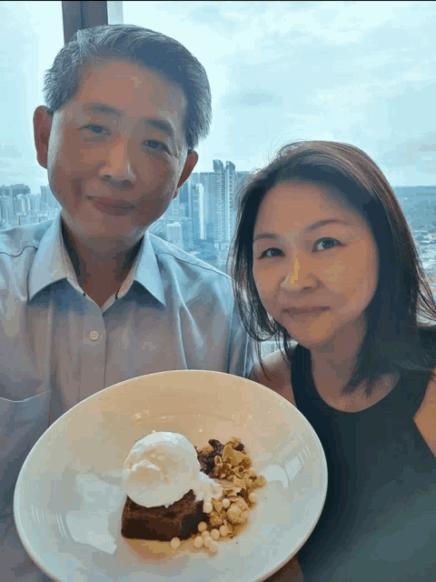 a man and a woman standing next to a plate of dessert