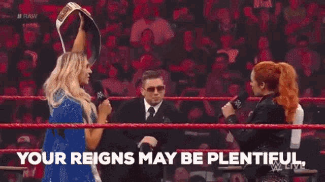 a woman in a wrestling ring holds up a championship belt and says but mine are meaningful