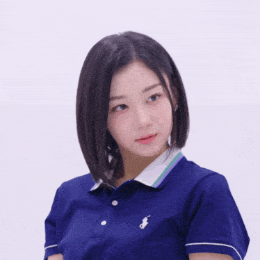 a woman wearing a purple polo shirt with a white horse on the front