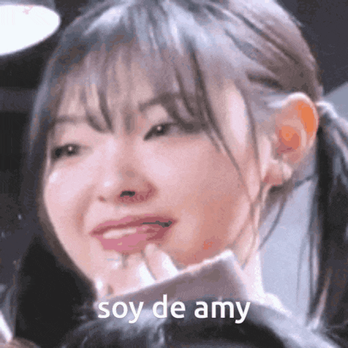 a close up of a woman 's face with the words soy de amy written on her face .