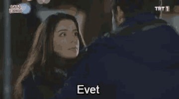a man and a woman are looking at each other and the woman is saying eve .