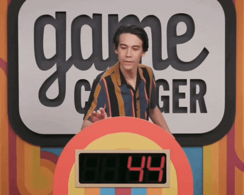 a man stands in front of a game called game changer