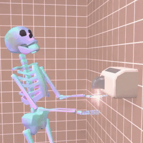 a skeleton is standing in front of a hand dryer