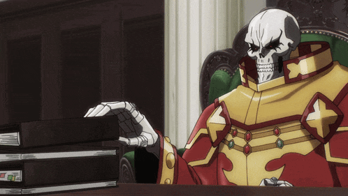 a skeleton in a red and gold outfit is sitting at a desk with binders on it