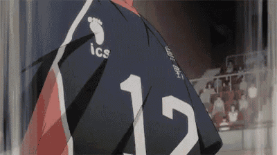 a close up of a person wearing a volleyball jersey with a number 12 on it .