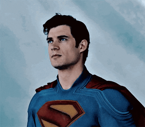 a close up of a man in a superman costume looking up .