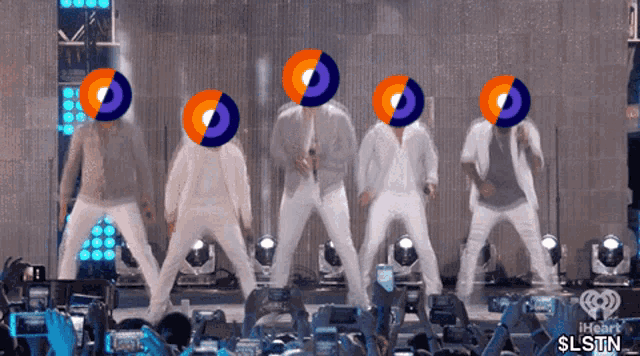 a group of men are dancing on a stage with their faces covered by circles that say iheart slstn
