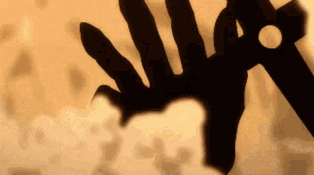 a silhouette of a person holding a sword with a hole in the middle