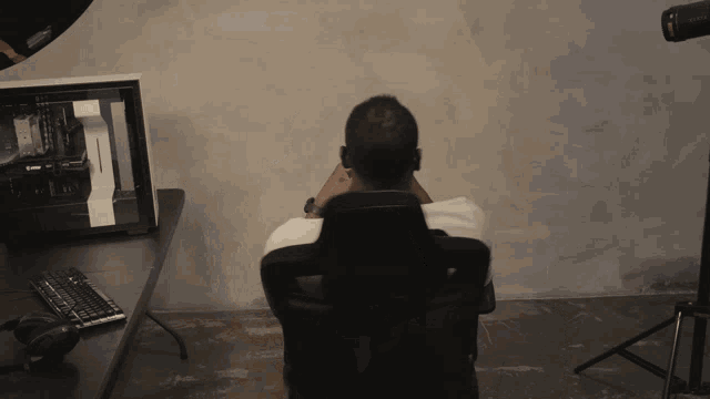 a man sits in a chair in front of a computer monitor with the word msi on it