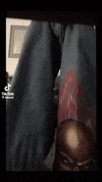 a person is wearing a pair of jeans with a skull on the side .