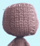 a close up of a stuffed animal 's head with stitches .