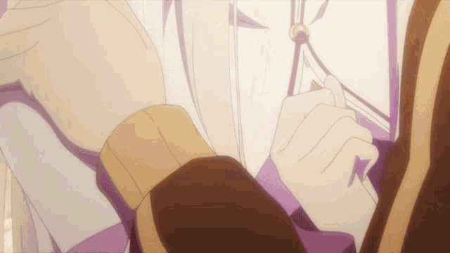 a close up of a person 's hand with a purple ribbon around it