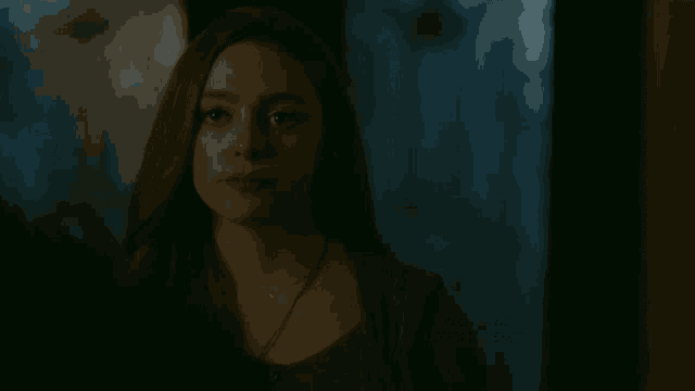 a woman in a dark room with the name chris grismer at the bottom