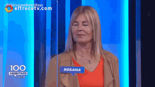 a woman wearing a name tag that says rosana on it