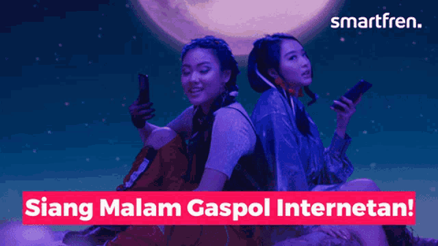 two women sitting next to each other looking at their phones with a smartfren logo behind them