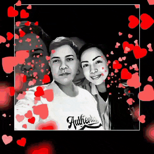 a black and white photo of a man and a woman with hearts around them