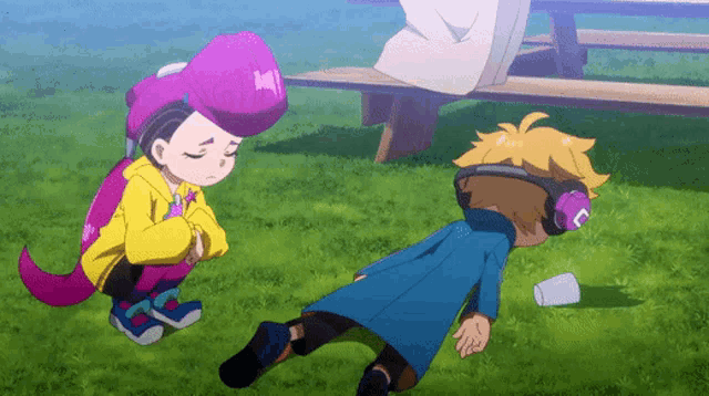 a boy wearing headphones is laying on the grass next to a girl wearing a purple hat with the letter h on it