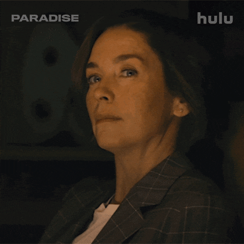 a close up of a woman 's face with a hulu logo in the background