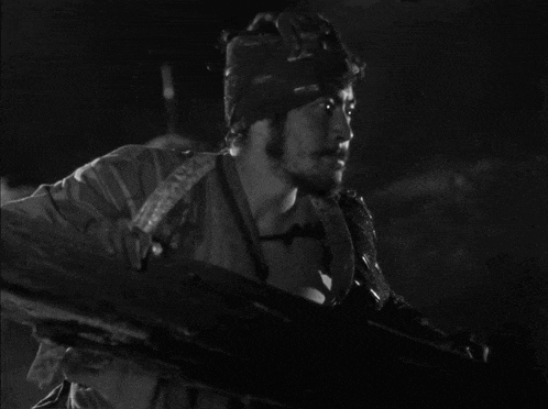 a black and white photo of a man in a military uniform