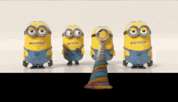 a group of minions are standing next to each other with a rainbow cone in the middle .