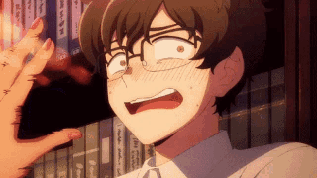 a man with glasses and a surprised look on his face is standing in front of a shelf of books
