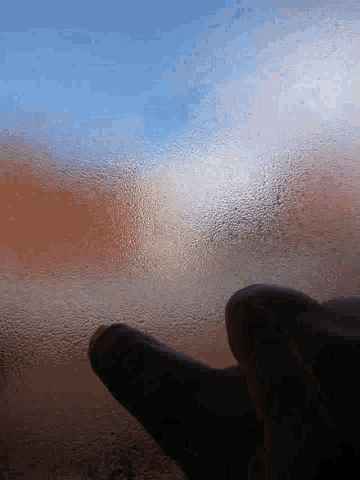 a close up of a person 's finger on a glass surface