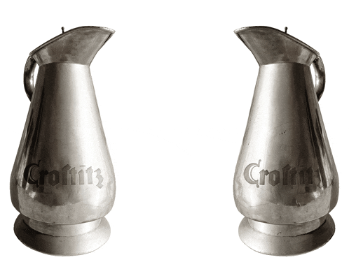 two silver pitchers with the word croftitz etched on them