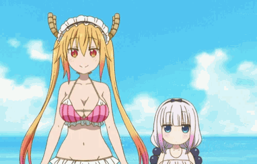 two anime girls are standing next to each other on the beach .