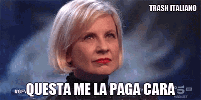 a woman says " questa me la paga cara " in front of a black background