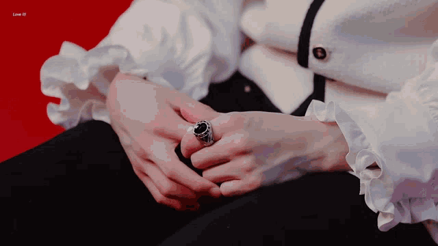 a close up of a person 's hands with a ring on their left hand