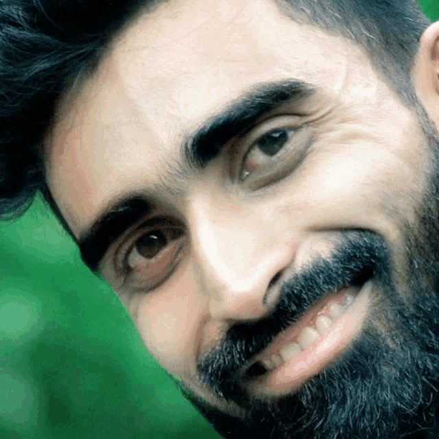 a close up of a man 's face with a beard
