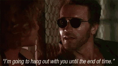 a man wearing sunglasses is talking to a woman who is holding his neck