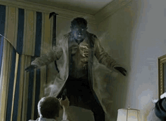 a man is taking a picture of a monster in a room