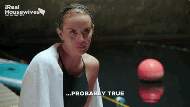 a woman with a towel around her neck says " probably true " in front of a pool