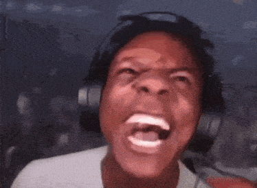 the man is wearing headphones and making a funny face .