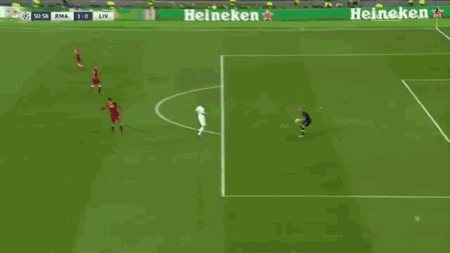 a soccer field with heineken advertisements on the side
