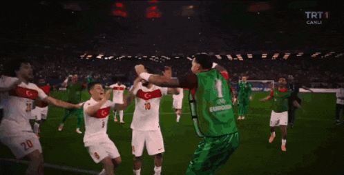 a group of soccer players on a field with one wearing a green jersey that says euro2020