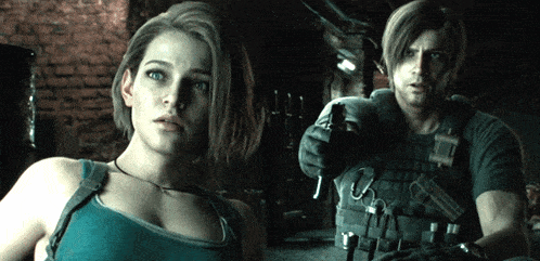 a man and a woman are standing next to each other and the woman is wearing a blue tank top