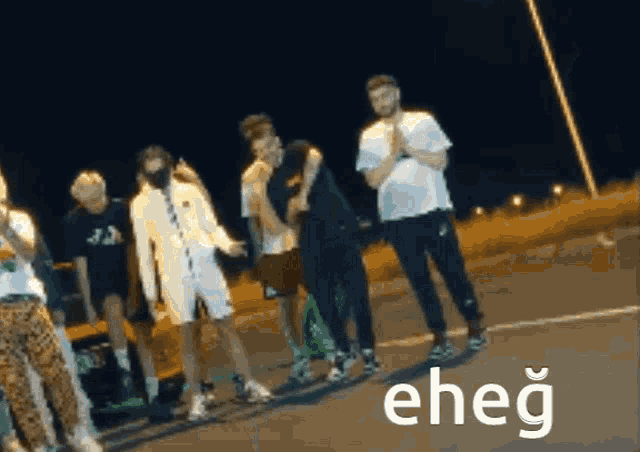 a group of people are standing next to each other and the word eheg is on the bottom