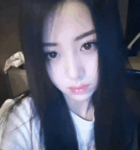 a close up of a woman 's face with long black hair