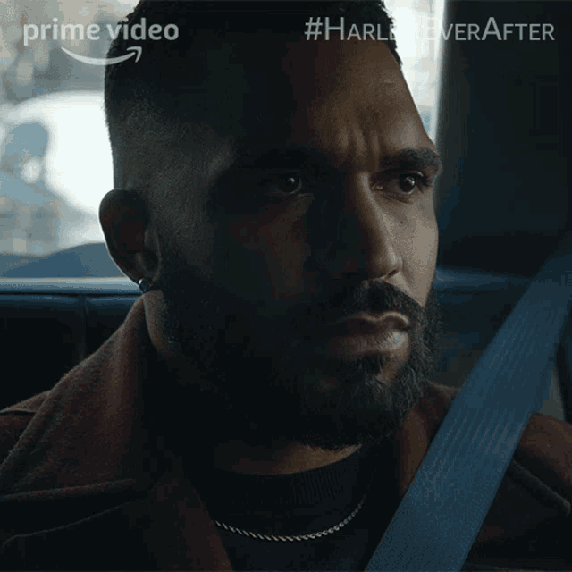 a man with a beard is sitting in the back seat of a car with #harley ever after written on the screen