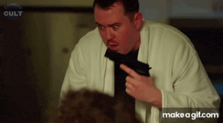 a man in a white coat is holding a gun in his hand